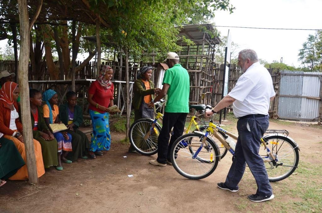 ChildFund Ethiopia Country Director Chege Ngugi and ChildFund Ireland CEO Michael Kiely presenting 'Dream Bikes' to school girls near Ropi, Ethiopia April 2016