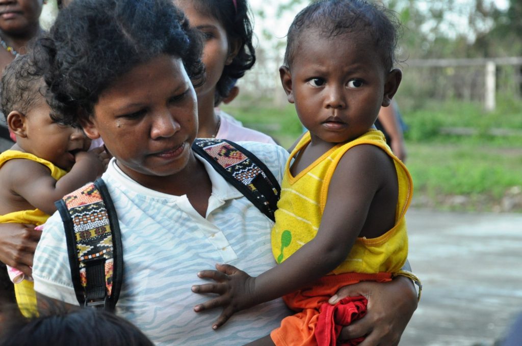mothers-and-their-children-line-up-to-receive-food-packs-during-childfunds-distribution-at-a-community-in-apayao-philippines-following-typhoon-haima-and-typhoon-lawin-in-2016