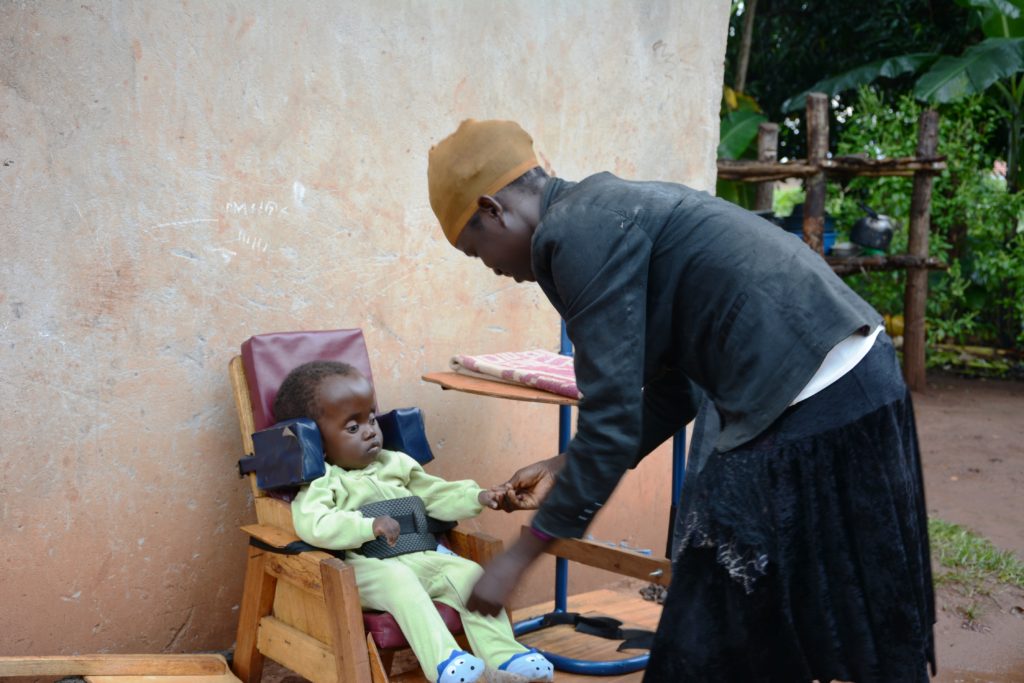 emmanuel being fastened in by his mum